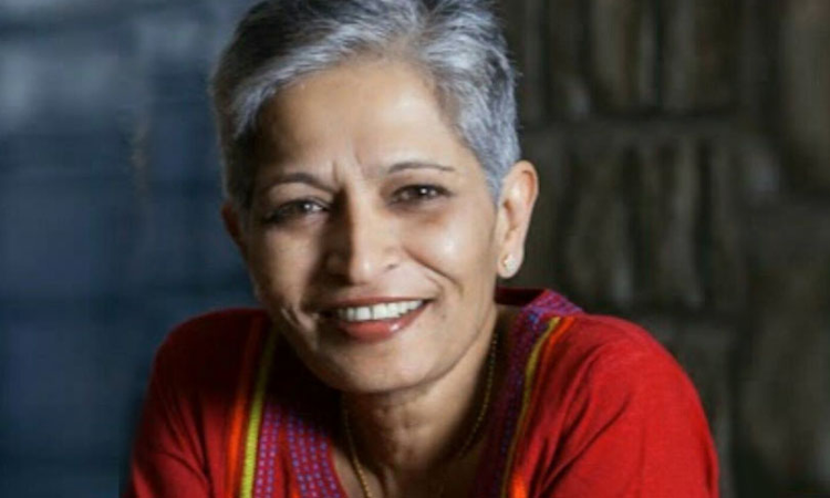 Gauri lankesh is wearing a red top with colorful embroidery, set against a blurred, dark background. The vibrancy of the attire contrasts the somber discussions on right-wing extremism in India.