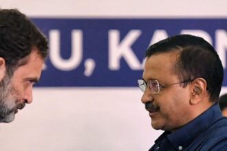 Congress leader Rahul Gandhi shakes hands with Delhi Chief Minister Arvind Kejriwal during the Opposition parties meet