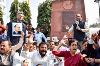 Atishi with AAP MLAs stages a protest outside the Legislative Assembly over removing BR Ambedkar's pictures from Delhi CM's office following her suspension from the Assembly, in New Delhi on Tuesday.