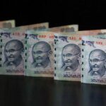 Rupee falls 2 paise to close at 87.21 against US dollar